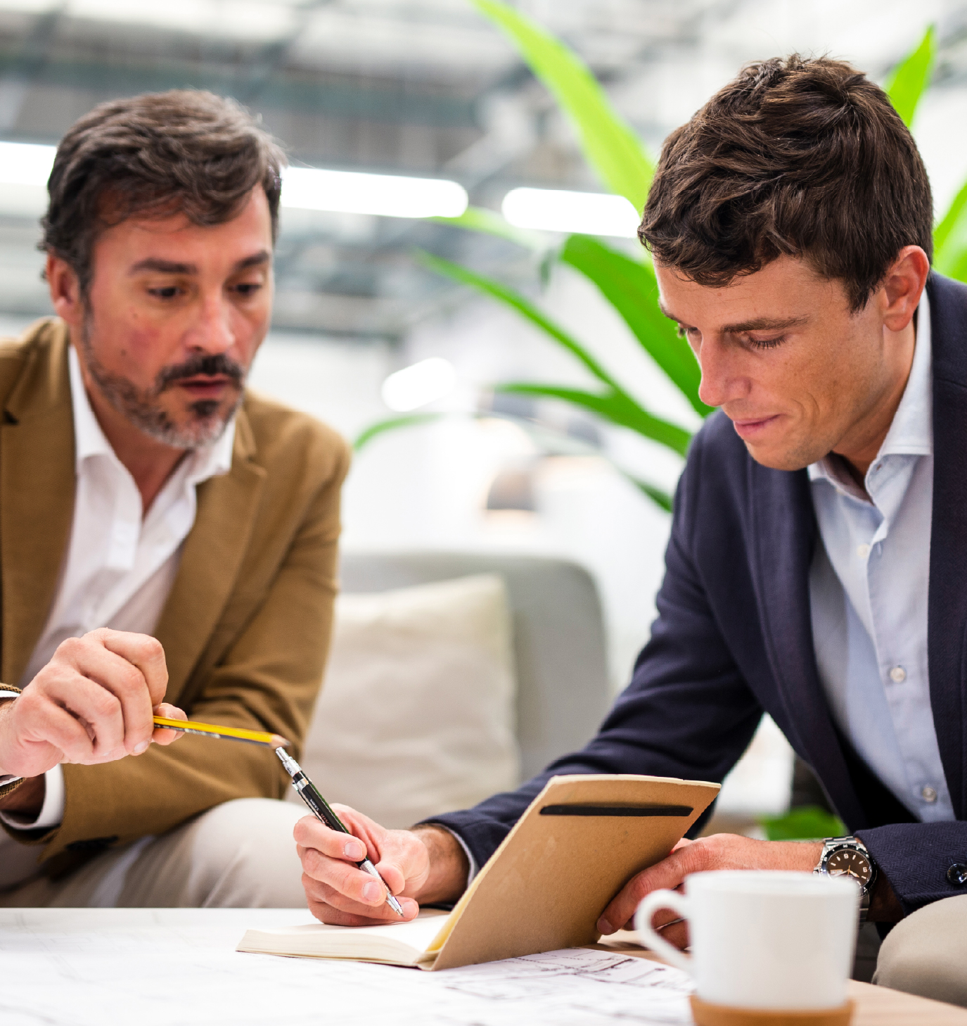 Two men writing - Emotional Support + Practical Insights